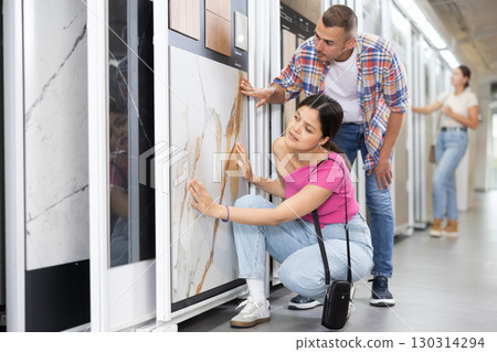 Couple of man and woman choose tiles in store 130314294