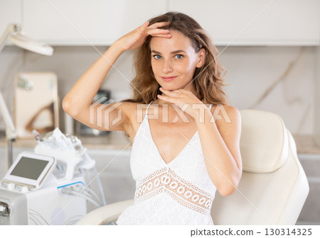 Middle-aged woman preparing for plastic surgery on her face in clinic Middle-aged woman preparing for plastic surgery on her face in clinic 130314325