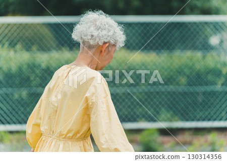 Senior woman walking unwell Senior woman walking unwell 130314356