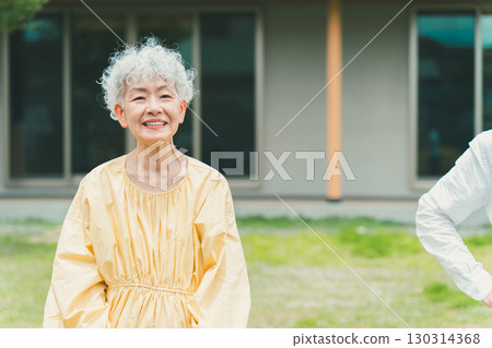 Smiling senior woman in her garden 130314368