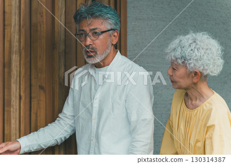 Elderly people looking at a model home Elderly people looking at a model home 130314387