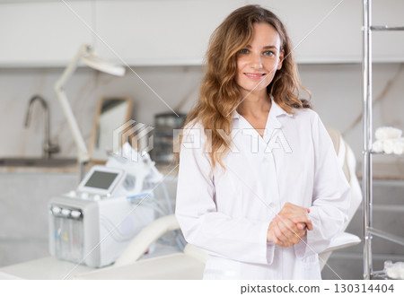 Skilled cosmetic doctor confidently stands Skilled cosmetic doctor confidently stands 130314404