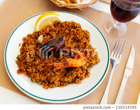 Seafood paella with mussels, calamari rings and prawns Seafood paella with mussels, calamari rings and prawns 130314595