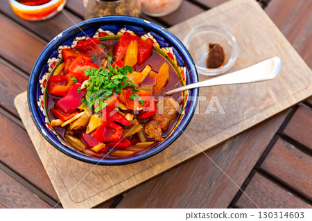Portion of Uyghur laghman served in soup bowl 130314603