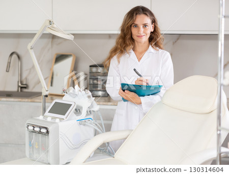 cosmetic doctor attentively reviews 130314604