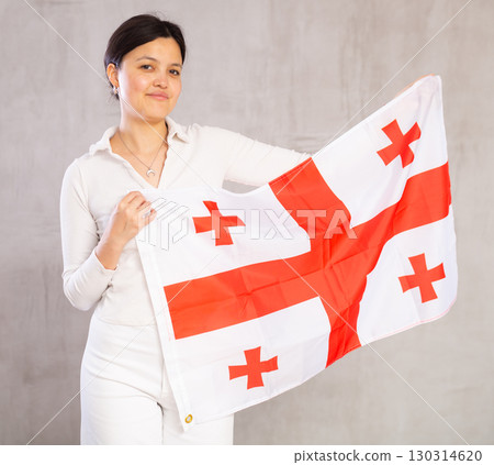 Young woman posing in studio with Georgia flag Young woman posing in studio with Georgia flag 130314620