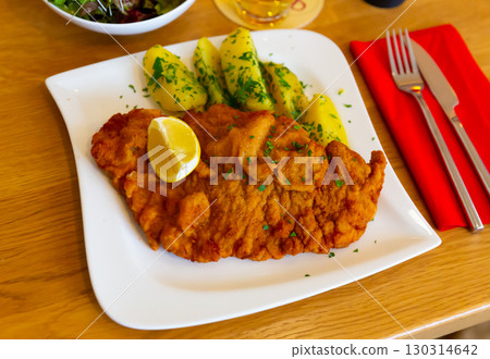 Appetizing breaded beef with potatoes Appetizing breaded beef with potatoes 130314642