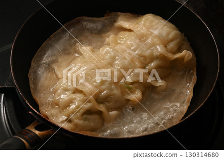 Baked dumplings cooking scene 130314680