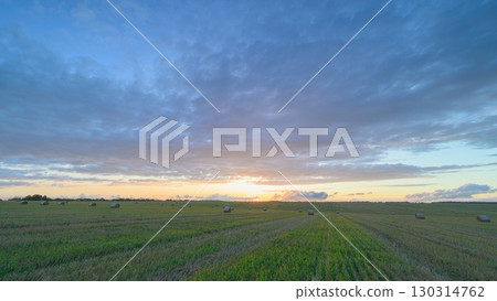 A Serene and Beautiful Sunrise Over Lush Green Fields for a Peaceful Morning Experience A Serene and Beautiful Sunrise Over Lush Green Fields for a Peaceful Morning Experience 130314762