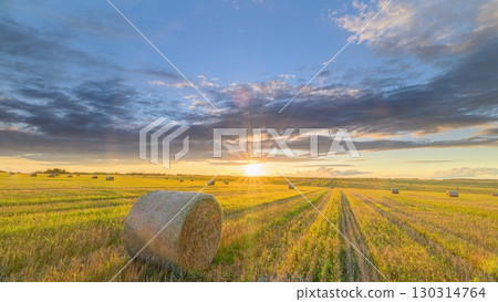 A Beautiful Golden Sunset Over Rolling Fields Filled with Bales of Hay Awaits You A Beautiful Golden Sunset Over Rolling Fields Filled with Bales of Hay Awaits You 130314764