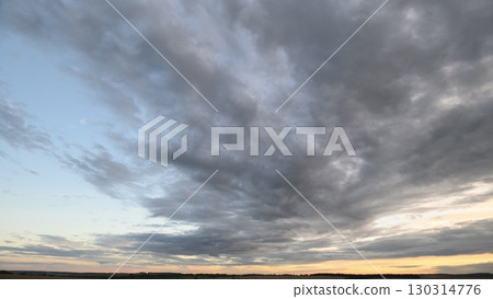 A Dramatic Cloudy Sky at Dusk Unfolds with Spectacular Colors and AweInspiring Beauty 130314776