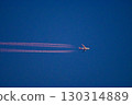 The contrails and jumbo jets dyed red by the setting sun after sunset 130314889