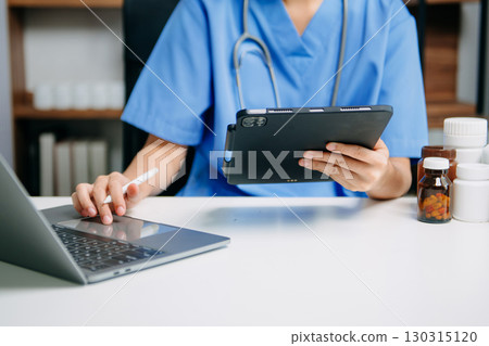 Medical technology concept. Doctor working with mobile phone and stethoscope and digital tablet laptop in modern office at hospital 130315120