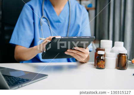 Medical technology concept. Doctor working with mobile phone and stethoscope and digital tablet laptop in modern office at hospital 130315127