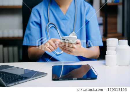 Medical technology concept. Doctor working with mobile phone and stethoscope and digital tablet laptop in modern office at hospital Medical technology concept. Doctor working with mobile phone and stethoscope and digital tablet laptop in modern office at hospital 130315133