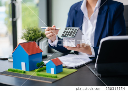 balancing the property sector The real estate agent is explaining the house style to see the house design and the purchase agreement. model house and comdo balancing the property sector The real estate agent is explaining the house style to see the house design and the purchase agreement. model house and comdo 130315154