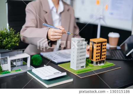 balancing the property sector The real estate agent is explaining the house style to see the house design and the purchase agreement. model house and comdo balancing the property sector The real estate agent is explaining the house style to see the house design and the purchase agreement. model house and comdo 130315186