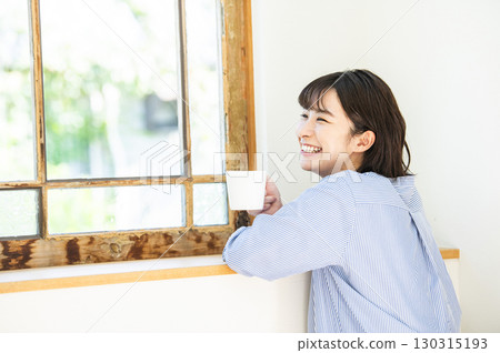 Young woman drinking coffee Young woman drinking coffee 130315193