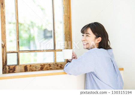 Young woman drinking coffee 130315194