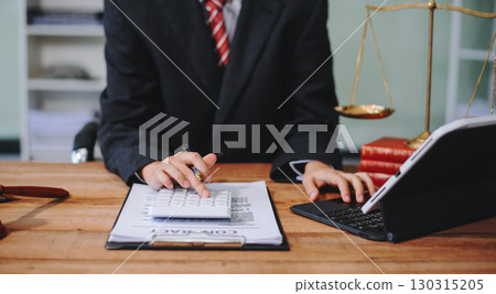 justice and law concept.businessman or lawyer or accountant working on accounts using a smart phone laptop digital tablet calculator justice and law concept.businessman or lawyer or accountant working on accounts using a smart phone laptop digital tablet calculator 130315205