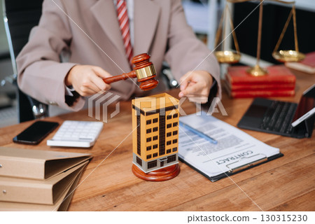 Real Estate Lawyer And House Foreclosure Law. House model, hammer judge gavel on table with white background. Real Estate Lawyer And House Foreclosure Law. House model, hammer judge gavel on table with white background. 130315230