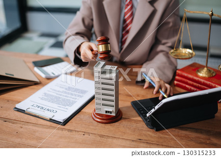 Real Estate Lawyer And House Foreclosure Law. House model, hammer judge gavel on table with white background. Real Estate Lawyer And House Foreclosure Law. House model, hammer judge gavel on table with white background. 130315233