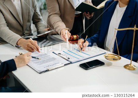 business people and lawyers discussing contract papers sitting at the table. Concepts of law, advice, legal services. 130315264