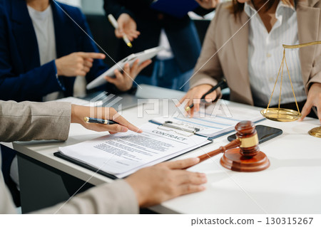 business people and lawyers discussing contract papers sitting at the table. Concepts of law, advice, legal services. 130315267