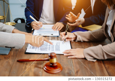 Business and lawyers discussing contract papers with brass scale on desk in office. Law, legal services, advice,  justice and law 130315272