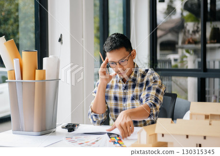 business man hand working and laptop with on on architectural project at construction site at desk business man hand working and laptop with on on architectural project at construction site at desk 130315345