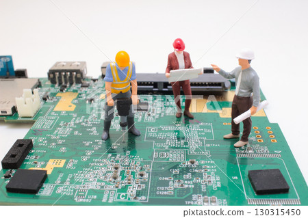 Miniature Engineers Working on a Circuit Board Construction Project Miniature Engineers Working on a Circuit Board Construction Project 130315450