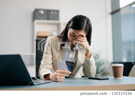Financial owe, hand of asian woman sitting, holding credit card, stressed by calculate expense from invoice or bill, no money to pay Financial owe, hand of asian woman sitting, holding credit card, stressed by calculate expense from invoice or bill, no money to pay 130315556