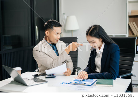 Furious two Asian businesspeople arguing strongly after making a mistake at work in modern office Furious two Asian businesspeople arguing strongly after making a mistake at work in modern office 130315593