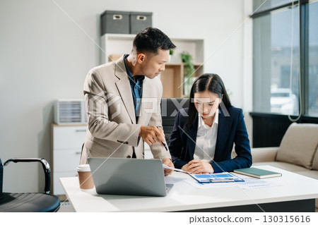 Furious two Asian businesspeople arguing strongly after making a mistake at work in modern office Furious two Asian businesspeople arguing strongly after making a mistake at work in modern office 130315616