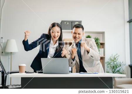 Happy businesspeople while collaborating on a new project in an office. team of diverse businesspeople using a laptop and tablet 130315621
