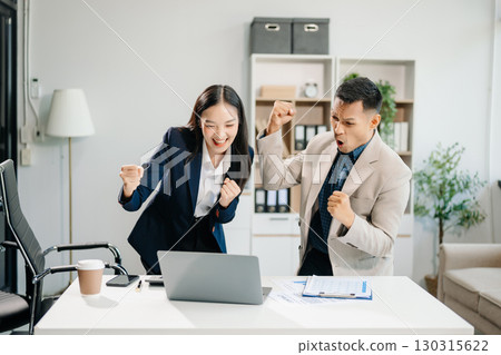 Asian businesswoman and man discuss investment project working and planning strategy with tablet laptop computer 130315622