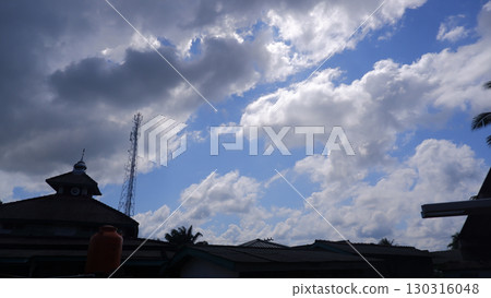 Dramatic Sky with Silhouetted Buildings and Communication Tower 130316048