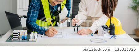Two colleagues discussing data working and tablet, laptop with architectural project at construction site at desk Two colleagues discussing data working and tablet, laptop with architectural project at construction site at desk 130316329