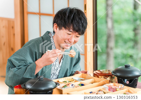 Young Asian man enjoying kaiseki cuisine at a ryokan (room service, kaiseki cuisine, gozen, luxury) Young Asian man enjoying kaiseki cuisine at a ryokan (room service, kaiseki cuisine, gozen, luxury) 130316353