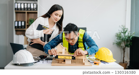 Creative architect projecting on the big drawings with architectural project at construction site at desk 130316380