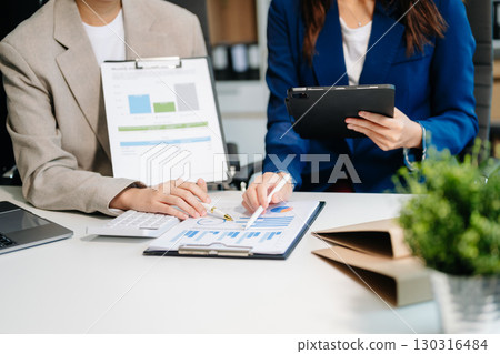 Businessman and team analyzing financial statement Finance task. with smart phone and laptop and  tablet. 130316484