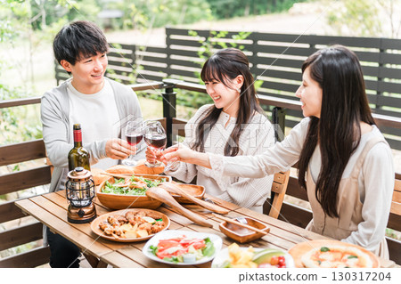 Group of young Asian men and women having a home party glamping on a wooden deck 130317204