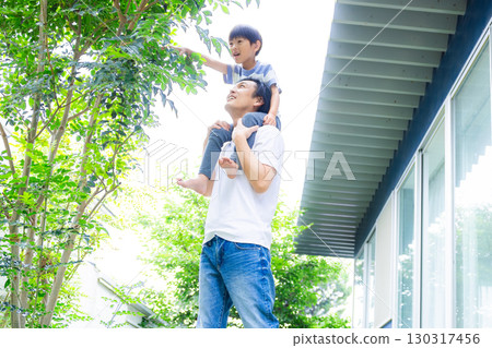 Family: Parents and children playing in the garden Family: Parents and children playing in the garden 130317456