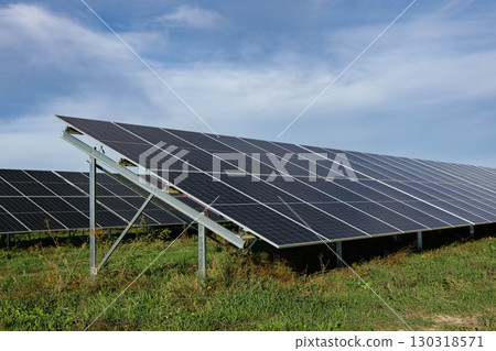 Solar panels providing clean energy under a cloudy sky Solar panels providing clean energy under a cloudy sky 130318571
