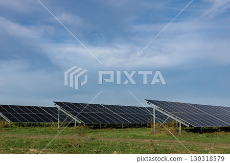 Solar panels providing renewable energy under a cloudy sky Solar panels providing renewable energy under a cloudy sky 130318579