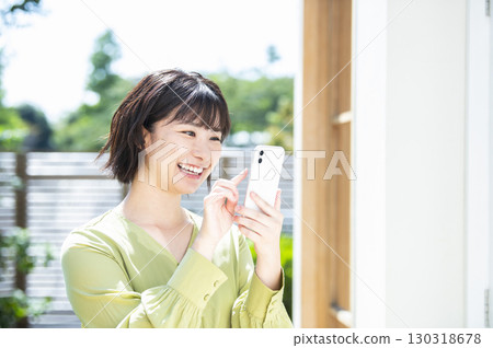 Young woman searching on her smartphone Young woman searching on her smartphone 130318678