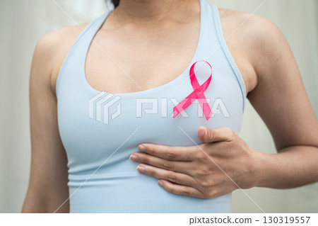 Breast cancer, pink ribbon at Asian senior lady for supporting awareness, symbol of World Breast Cancer Day. 130319557