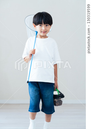 Boy holding a butterfly net Boy holding a butterfly net 130319599