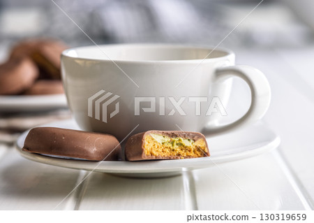 Dubai style chocolate cookies and coffee cup on white table. Dubai style chocolate cookies and coffee cup on white table. 130319659