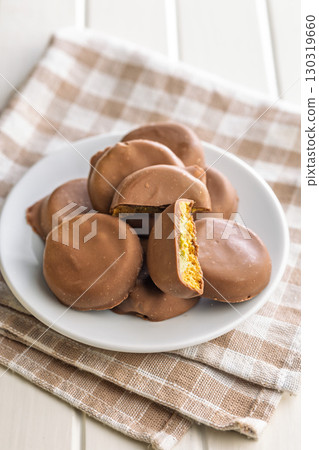 Dubai style chocolate cookies on plate on checkered napkin. 130319660